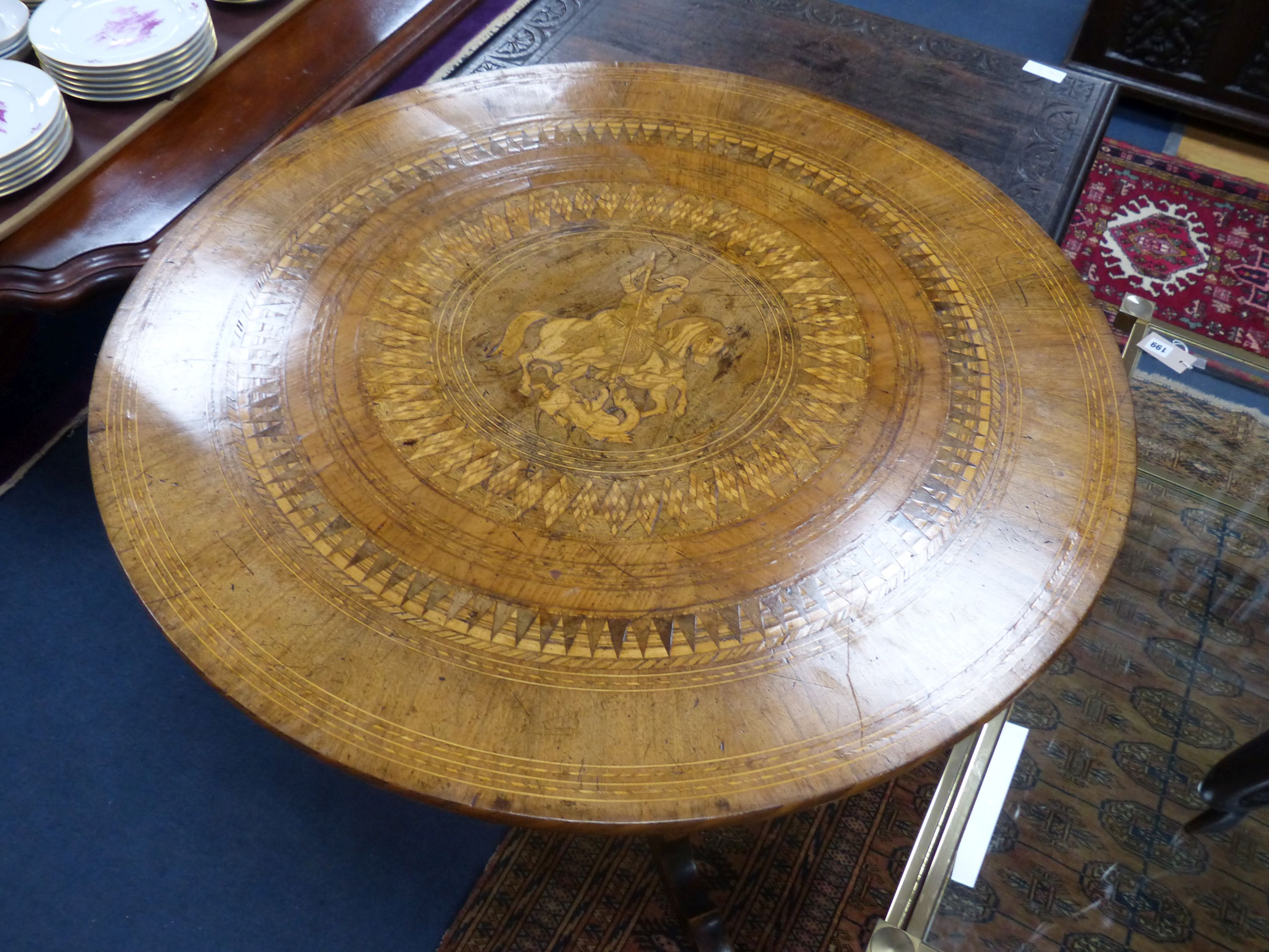 A 19th century Sorrento inlaid table, decorated centrally with a scene of St. George slaying the dragon, diameter 89cm, height 77cm